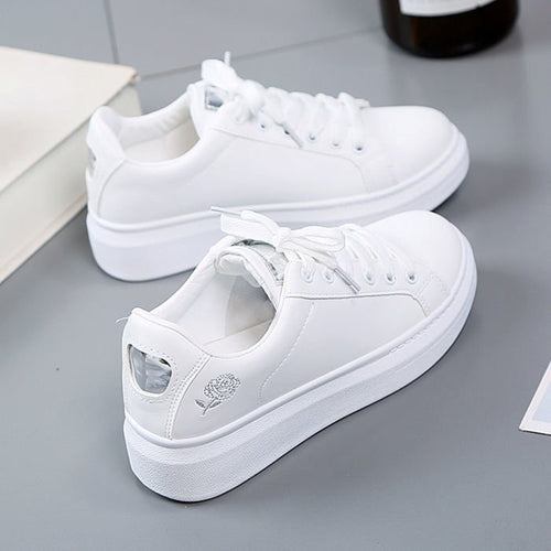 Simple rose embroidered white sneakers for women, flat and casual.